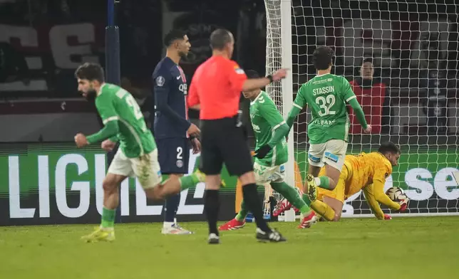 PSG's goalkeeper Gianluigi Donnarumma, right, misses a goal by Saint-Etienne's Zuriko Davitashvili, left, during the French League One soccer match between Paris Saint-Germain and Saint-Etienne at the Parc des Princes stadium in Paris, France, Sunday, Jan. 12, 2025. (AP Photo/Michel Euler)