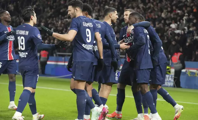 PSG's Ousmane Dembele, second from right, celebrates with teammates after scoring his side's second goal during the French League One soccer match between Paris Saint-Germain and Saint-Etienne at the Parc des Princes stadium in Paris, France, Sunday, Jan. 12, 2025. (AP Photo/Michel Euler)