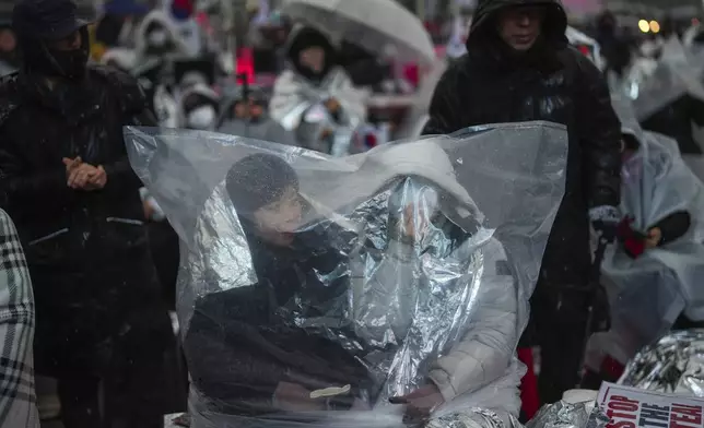 Supporters of impeached South Korean President Yoon Suk Yeol attend a rally to oppose his impeachment near the presidential residence in Seoul, South Korea, Monday, Jan. 13, 2025. (AP Photo/Lee Jin-man)