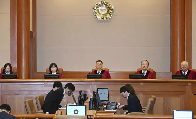 South Korea's Constitutional Court's judges, from left, Jung Jung-mi, Lee Mi-son, acting Chief Justice Moon Hyung-bae, Kim Hyung-du and Cheong Hyung-sik sit for the first formal hearing of a trial on the validity of President Yoon Suk Yeol's impeachment by the National Assembly at the constitutional court of Korea in Seoul, South Korea, Tuesday, Jan. 14, 2025. (Kim Min-Hee/Pool Photo via AP)
