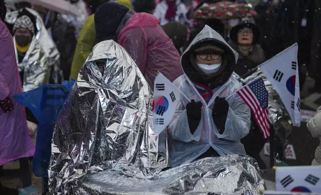 Supporters of impeached South Korean President Yoon Suk Yeol shout slogans during a rally to oppose his impeachment near the presidential residence in Seoul, South Korea, Monday, Jan. 13, 2025. (AP Photo/Lee Jin-man)