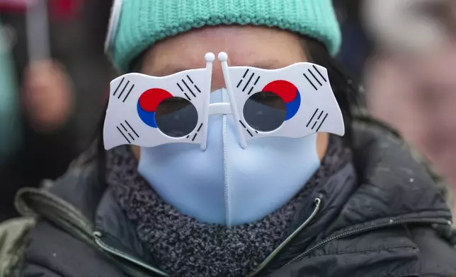A supporter of impeached South Korean President Yoon Suk Yeol attends a rally to oppose his impeachment near the presidential residence in Seoul, South Korea, Monday, Jan. 13, 2025. (AP Photo/Lee Jin-man)