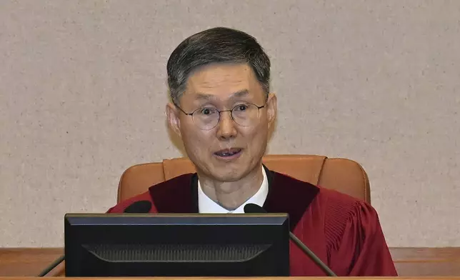 Judge Moon Hyung-bae, acting chief justice of South Korea's Constitutional Court, sits for the first formal hearing of a trial on the validity of President Yoon Suk Yeol's impeachment by the National Assembly at the constitutional court of Korea in Seoul, South Korea, Tuesday, Jan. 14, 2025. (Kim Min-Hee/Pool Photo via AP)