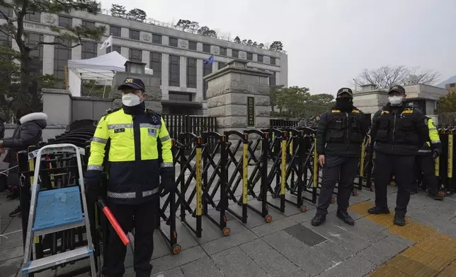 South Korean police officers stand in front of the Constitutional Court in Seoul, South Korea, Tuesday, Jan. 14, 2025. (AP Photo/Lee Jin-man)