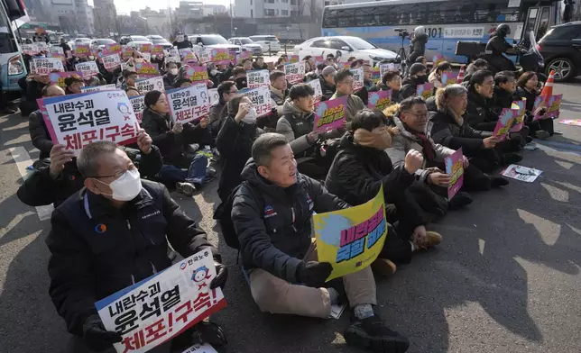 Protesters stage a rally demanding the arrest of impeached South Korean President Yoon Suk Yeol near the presidential residence in Seoul, South Korea, Sunday, Jan. 12, 2025. The letters read "Arrest Yoon Suk Yeol." (AP Photo/Ahn Young-joon)