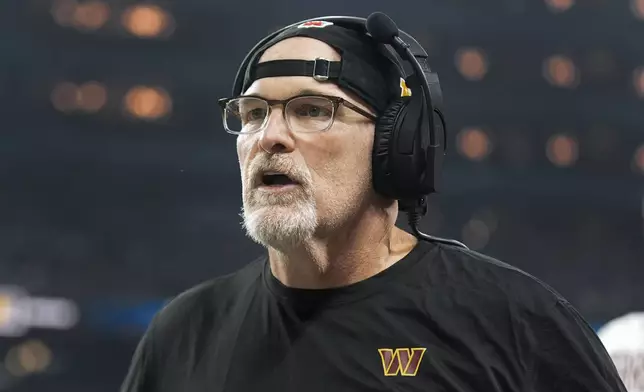 Washington Commanders head coach Dan Quinn watches against the Detroit Lions during the first half of an NFL football divisional playoff game, Saturday, Jan. 18, 2025, in Detroit. (AP Photo/Seth Wenig)