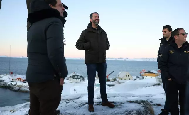 Donald Trump Jr., center, smiles after arriving in Nuuk, Greenland, Tuesday, Jan. 7, 2025. (Emil Stach/Ritzau Scanpix via AP)