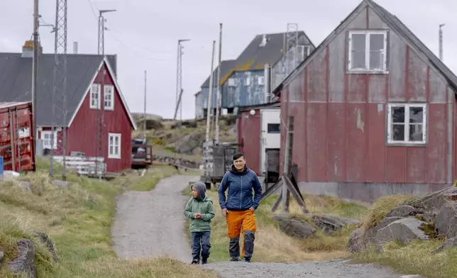 FILE - Local residents walk in the settlement Attu, in the Qeqertalik municipality, western Greenland, Monday, July 1, 2024. (Ida Marie Odgaard/Ritzau Scanpix via AP, File)