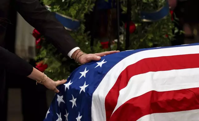 The Carter family pay their respects during a ceremony as the flag-draped casket of former President Jimmy Carter lies in state, at the Capitol, Tuesday, Jan. 7, 2025, in Washington. Carter died Dec. 29 at the age of 100. (Kent Nishimura/The New York Times via AP, Pool)