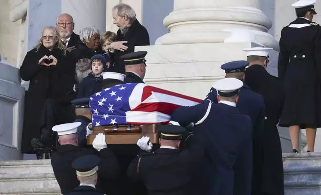 A joint services military body bearer team carries the flag-draped casket of former President Jimmy Carter up the steps into the U.S Capitol, Tuesday, Jan. 7, 2025, in Washington. Carter died Dec. 29 at the age of 100. (Evelyn Hockstein/Pool via AP)