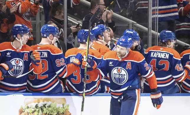 Edmonton Oilers' Leon Draisaitl (29) celebrates after a goal against the Anaheim Ducks during third-period NHL hockey game action in Edmonton, Alberta, Friday, Jan. 3, 2025. (Jason Franson/The Canadian Press via AP)