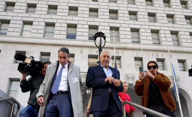 Attorneys Mark Geragos, center, and Bryan Freedman, left, leave before a news conference held by Los Angeles County District Attorney Nathan Hochman regarding resentencing of Erik and Lyle Menendez for the murders of their parents, in Los Angeles on Friday, Jan. 3, 2025. (AP Photo/Damian Dovarganes)