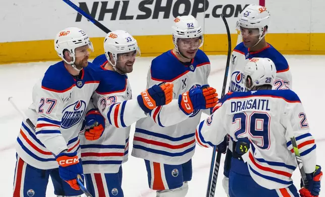 Edmonton Oilers right wing Vasily Podkolzin, third from left, celebrates after his goal against the Seattle Kraken with teammates Brett Kulak (27), left wing Viktor Arvidsson (33), defenseman Darnell Nurse (25) and center Leon Draisaitl (29) during the first period of an NHL hockey game Saturday, Jan. 4, 2025, in Seattle. (AP Photo/Lindsey Wasson)