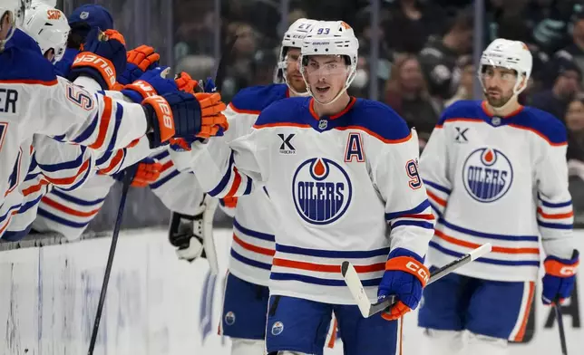 Edmonton Oilers center Ryan Nugent-Hopkins (93) celebrates with the bench after his goal during the second period of an NHL hockey game against the Seattle Kraken, Saturday, Jan. 4, 2025, in Seattle. (AP Photo/Lindsey Wasson)