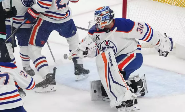 Edmonton Oilers goaltender Calvin Pickard (30) blocks a shot by the Seattle Kraken during the first period of an NHL hockey game Saturday, Jan. 4, 2025, in Seattle. (AP Photo/Lindsey Wasson)