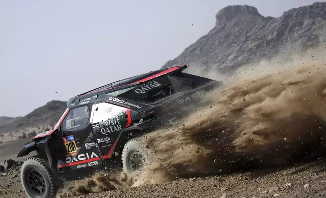 Driver Nasser Al-Attiyah and co-driver Edouard Boulanger compete during the prologue of the Dakar Rally in Bisha, Saudi Arabia, Friday, Jan. 3, 2025. (AP Photo/Christophe Ena)