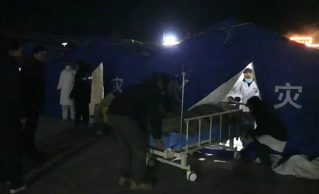 In this photo released by Xinhua News Agency, medical workers treat injured people at the temporary tents set up at the People's Hospital in the aftermath of an earthquake in Dingri County in Xigaze, southwest China's Xizang Autonomous Region on Tuesday, Jan. 7, 2025. (Ding Ting/Xinhua via AP)