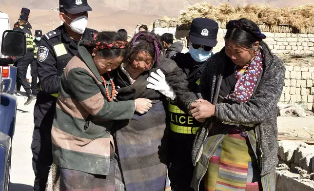 In this photo released by Xinhua News Agency, rescuers transfer the injured at Zhacun Village of Dingri County in Xigaze, southwest China's Tibet Autonomous Region, Tuesday Jan. 7, 2025. (Xinhua via AP)