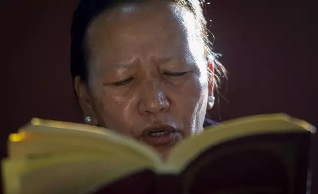 A Tibetan woman offers a prayer in the remembrance of those who lost their lives in the recent earthquake, at a Tibetan camp in Lalitpur, Nepal, on Wednesday, Jan. 8, 2025. (AP Photo/Niranjan Shrestha)