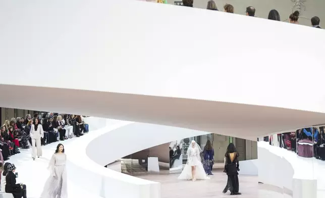 Models wear creations as part of the Chanel Haute Couture Spring Summer 2025 collection, that was presented in Paris, Tuesday, Jan. 28, 2025. (AP Photo/Lewis Joly).