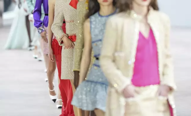 Models wear creations as part of the Chanel Haute Couture Spring Summer 2025 collection, that was presented in Paris, Tuesday, Jan. 28, 2025. (AP Photo/Lewis Joly).