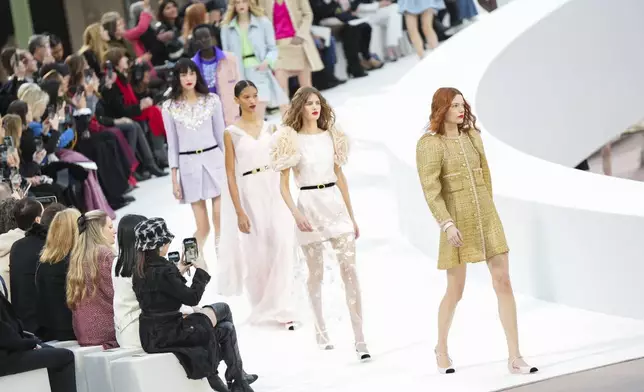 Models wear creations as part of the Chanel Haute Couture Spring Summer 2025 collection, that was presented in Paris, Tuesday, Jan. 28, 2025. (AP Photo/Lewis Joly).