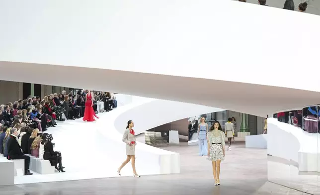 Models wear creations as part of the Chanel Haute Couture Spring Summer 2025 collection, that was presented in Paris, Tuesday, Jan. 28, 2025. (AP Photo/Lewis Joly).