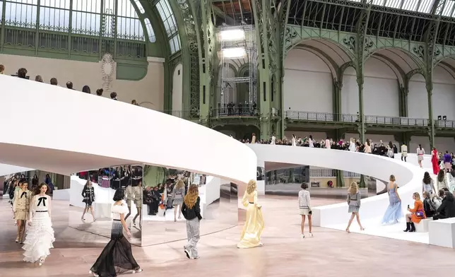 Models wear creations as part of the Chanel Haute Couture Spring Summer 2025 collection, that was presented in Paris, Tuesday, Jan. 28, 2025. (AP Photo/Lewis Joly).