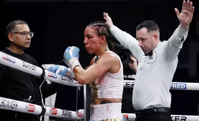 The referee calls the fight as Jessica Camara stands in a corner after losing to Caroline Dubois in a WBC world lightweight championship boxing match at the Canon Medical Arena, Sheffield, England, Saturday, Jan. 11, 2025. (Richard Sellers/PA via AP)