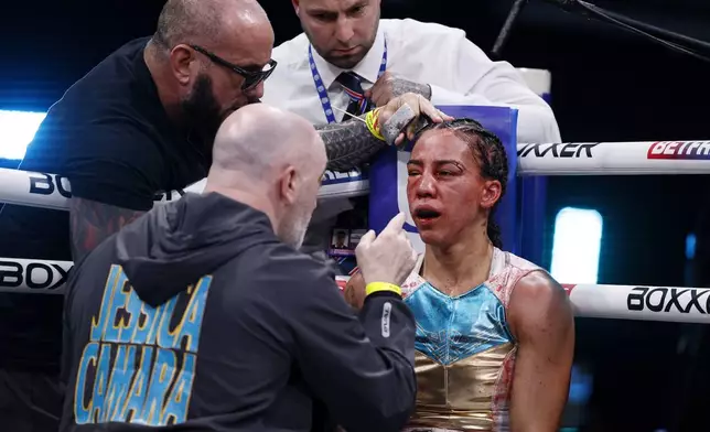 Jessica Camara is tended too in her corner during a WBC world lightweight championship boxing match against Caroline Dubois at the Canon Medical Arena, Sheffield, England, Saturday, Jan. 11, 2025. (Richard Sellers/PA via AP)
