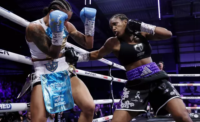 Caroline Dubois, right, punches and Jessica Camara during a WBC world lightweight championship boxing match at the Canon Medical Arena, Sheffield, England, Saturday, Jan. 11, 2025. (Richard Sellers/PA via AP)