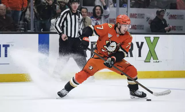 Anaheim Ducks right wing Frank Vatrano (77) looks to pass the puck after breaking away with a Tampa Bay Lightning empty net during the third period of an NHL hockey game Sunday, Jan. 5, 2025, in Anaheim, Calif. (AP Photo/William Liang)