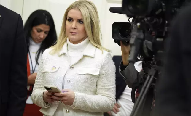 White House press secretary Karoline Leavitt watches as President Donald Trump signs executive orders in the Oval Office of the White House, Monday, Jan. 20, 2025, in Washington. (AP Photo/Evan Vucci)