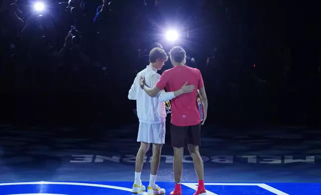 Jannik Sinner of Italy, left, is congratulated by Alexander Zverev of Germany following the men's singles final at the Australian Open tennis championship in Melbourne, Australia, Sunday, Jan. 26, 2025. (AP Photo/Vincent Thian)