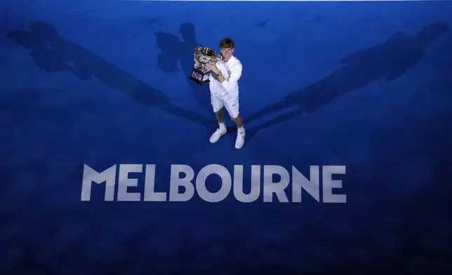 Jannik Sinner of Italy holds the Norman Brookes Challenge Cup after defeating Alexander Zverev of Germany in the men's singles final at the Australian Open tennis championship in Melbourne, Australia, Sunday, Jan. 26, 2025. (AP Photo/Manish Swarup)