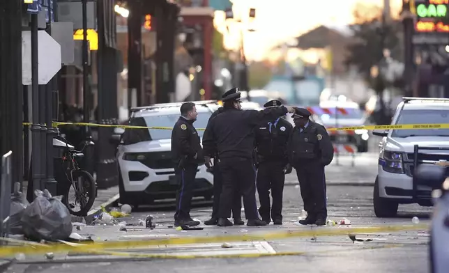 Security personnel gather at the scene on Bourbon Street after a vehicle drove into a crowd on New Orleans' Canal and Bourbon Street, Wednesday Jan. 1, 2025. (AP Photo/Gerald Herbert)