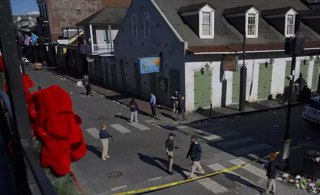 Members of the FBI walk around Bourbon Street during the investigation of a truck fatally crashing into pedestrians on Bourbon Street in the French Quarter in New Orleans, Wednesday, Jan. 1, 2025. (AP Photo/Matthew Hinton)