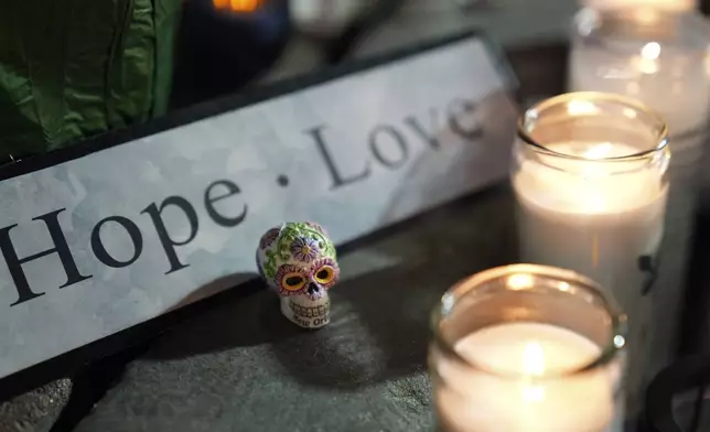 A memorial sits outside a restaurant along Bourbon Street in the French Quarter, Thursday, Jan. 2, 2025 in New Orleans. (AP Photo/George Walker IV)