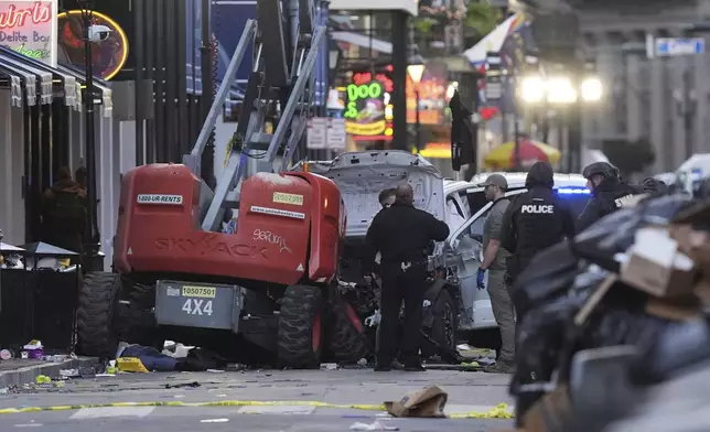 EDS NOTE: GRAPHIC CONTENT - Emergency personnel work the scene on Bourbon Street after a vehicle drove into a crowd on New Orleans' Canal and Bourbon Street, Wednesday Jan. 1, 2025. (AP Photo/Gerald Herbert)