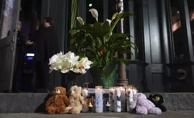 A memorial sits outside a restaurant along Bourbon Street in the French Quarter, Thursday, Jan. 2, 2025 in New Orleans. (AP Photo/George Walker IV)