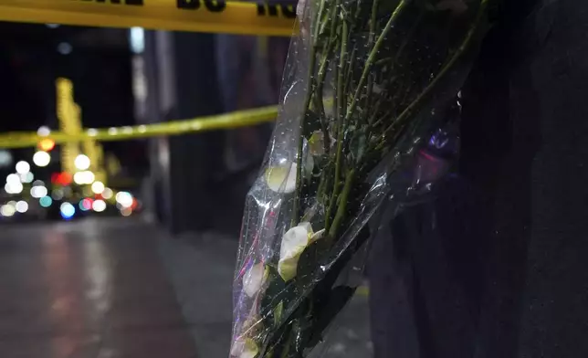 Flowers are seen near where a vehicle drove into a crowd on New Orleans' Canal and Bourbon streets, Wednesday, Jan. 1, 2025. (AP Photo/George Walker IV)