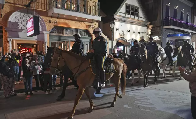 Mounted police patrol along Bourbon Street in the French Quarter, Thursday, Jan. 2, 2025 in New Orleans. (AP Photo/George Walker IV)