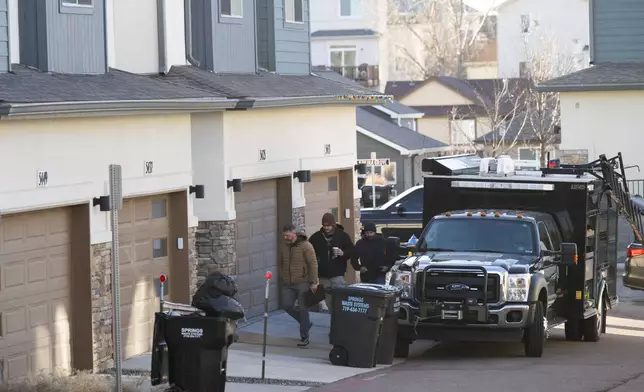 Investigators enter a townhouse in northeastern Colorado Springs, Colo., Thursday, Jan. 2, 2025, as the investigation connected to the explosion of a Tesla Cybertruck outside President-elect Donald Trump's Las Vegas hotel continues. (Christian Murdock/The Gazette via AP)