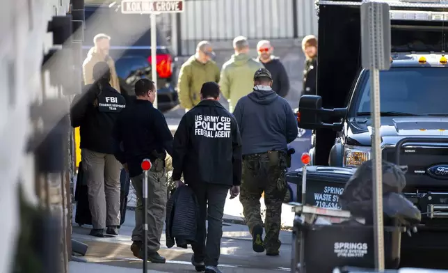 Investigators search a townhouse in northeastern Colorado Springs, Colo., Thursday, Jan. 2, 2025, as the investigation connected to the explosion of a Tesla Cybertruck outside President-elect Donald Trump's Las Vegas hotel continues. (Parker Seibold /The Gazette via AP)