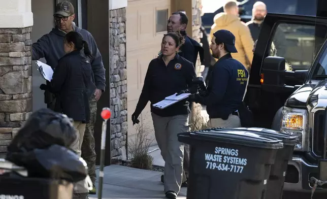 Investigators search a townhouse in northeastern Colorado Springs, Colo., Thursday, Jan. 2, 2025, as the investigation connected to the explosion of a Tesla Cybertruck outside President-elect Donald Trump's Las Vegas hotel continues. (Parker Seibold /The Gazette via AP)