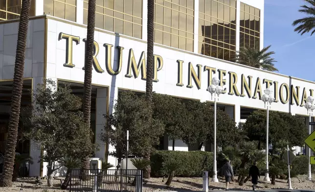 People walk by Trump International Hotel in Las Vegas Thursday, Jan. 2, 2025, in Las Vegas. (AP Photo/Ian Maule)