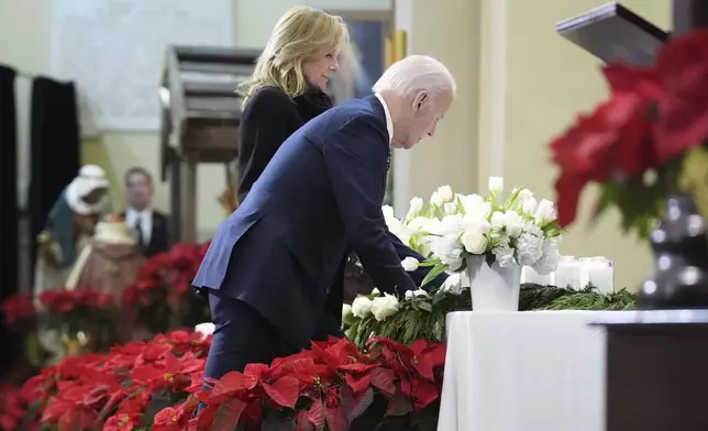 President Joe Biden and first lady Jill Biden place a candle at the alter as they participate in an interfaith prayer service for the victims of the deadly New Years truck attack, at St. Louis Cathedral in New Orleans, Monday, Jan. 6, 2025. (AP Photo/Stephanie Scarbrough)