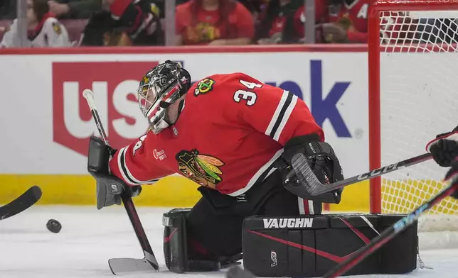 Chicago Blackhawks goaltender Petr Mrazek (34) deflects a shot by the Colorado Avalanche during the first period of an NHL hockey game Wednesday, Jan. 8, 2025, in Chicago. (AP Photo/Erin Hooley)