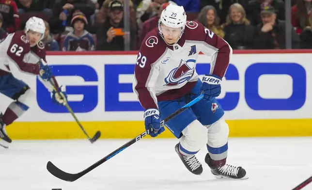 Colorado Avalanche center Nathan MacKinnon (29) handles the puck during the first period of an NHL hockey game against the Chicago Blackhawks, Wednesday, Jan. 8, 2025, in Chicago. (AP Photo/Erin Hooley)