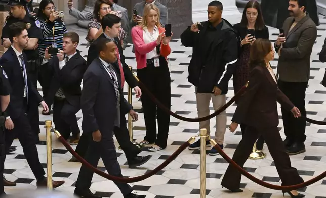 Vice President Kamala Harris, right, walks through Statuary Hall to the House Chamber before a joint session of Congress convenes to confirm the Electoral College votes, affirming President-elect Donald Trump’s victory in the presidential election, Monday, Jan. 6, 2025, at the U.S. Capitol in Washington. (AP Photo/John McDonnell)